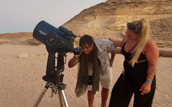Stargazing with telescope in Sharm El Sheikh desert during Bedouin dinner experience.