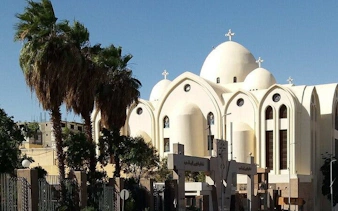 Mosque with domes and palm trees in Sharm El Sheikh during a private city tour.