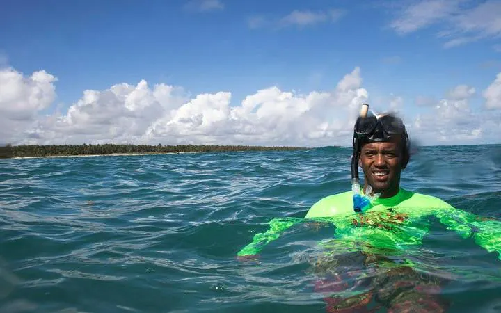 Snorkeler enjoying clear waters on a catamaran cruise in Punta Cana.