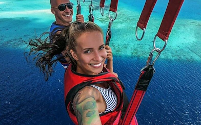 Parasailing over the Red Sea with a view of clear blue waters in Hurghada.