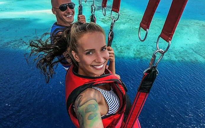 Parasailing over the Red Sea with a view of clear blue waters in Hurghada.