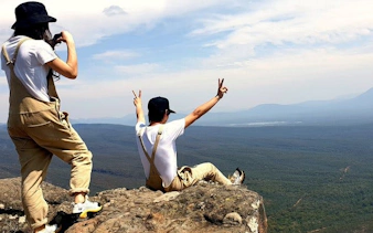 Hikers enjoying the view from a cliff in Grampians National Park.