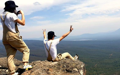Hikers enjoying the view from a cliff in Grampians National Park.