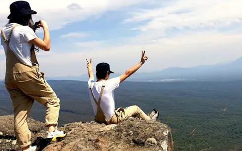 Hikers enjoying the view from a cliff in Grampians National Park.