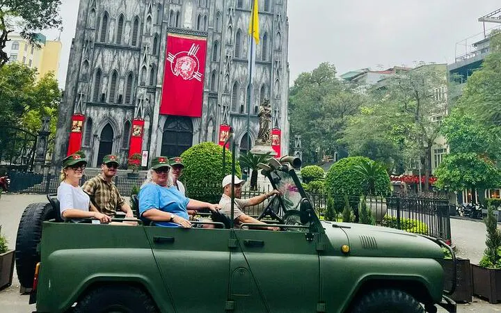 Tourists in a jeep in front of St. Joseph's Cathedral, Hanoi, during city tour.