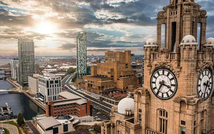 Liverpool skyline with Royal Liver Building clock tower during sunset.