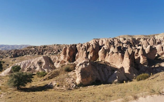 Cappadocia rock formations under clear sky during private trekking tour.