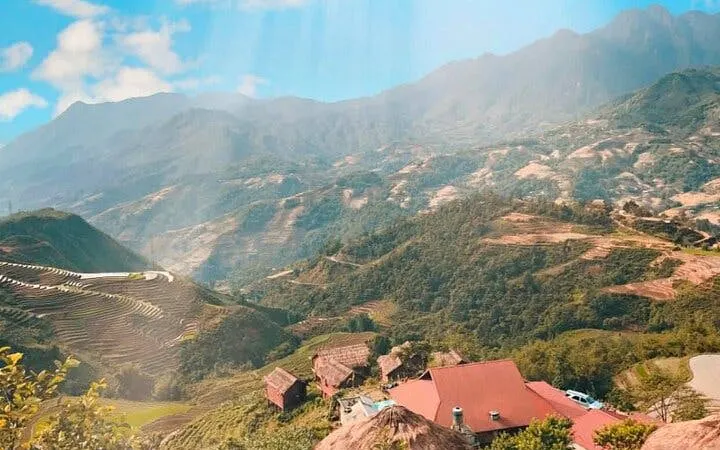 Sapa mountain landscape with terraced fields and traditional houses.