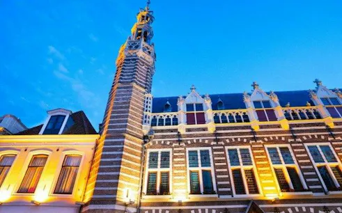 Alkmaar historic building with illuminated facade during self-guided audio walking tour.