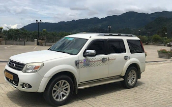 SUV for Sapa to Mu Cang Chai transport with mountain backdrop.