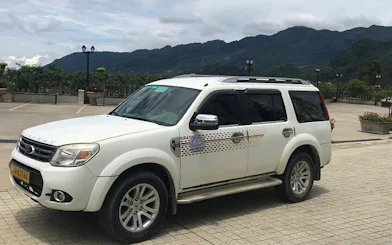 SUV for Sapa to Mu Cang Chai transport with mountain backdrop.