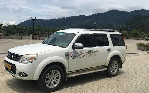 SUV for Sapa to Mu Cang Chai transport with mountain backdrop.