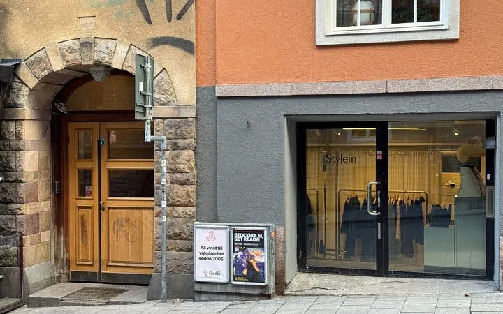 Millennium Trilogy tour location with historic building and modern storefront in Stockholm.
