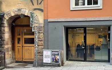 Millennium Trilogy tour location with historic building and modern storefront in Stockholm.