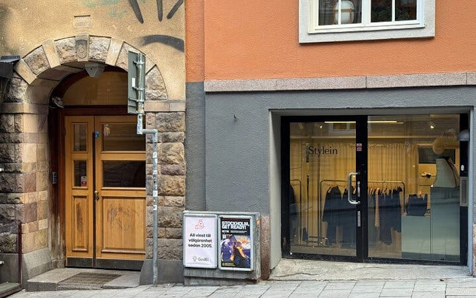 Millennium Trilogy tour location with historic building and modern storefront in Stockholm.