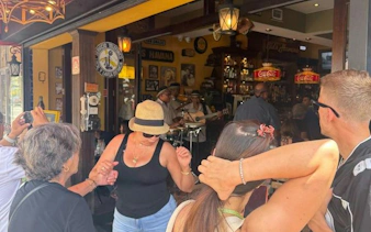 Visitors enjoying live music and dancing at a café in Little Havana, Miami.