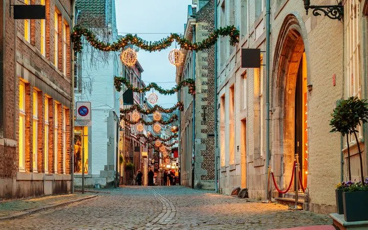 Maastricht street with festive lights during self-guided walking tour.