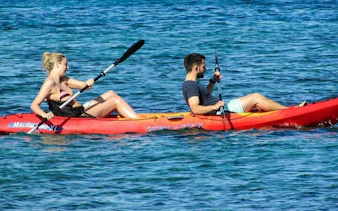 Kayakers paddling through clear waters on Key Largo Mangrove Kayak Adventure, Miami.