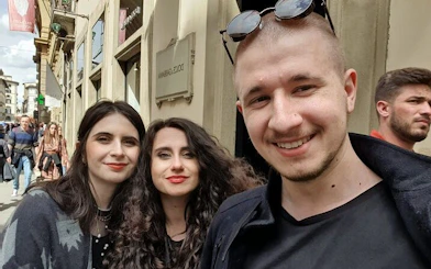 Group exploring Florence street during haunted city game tour.