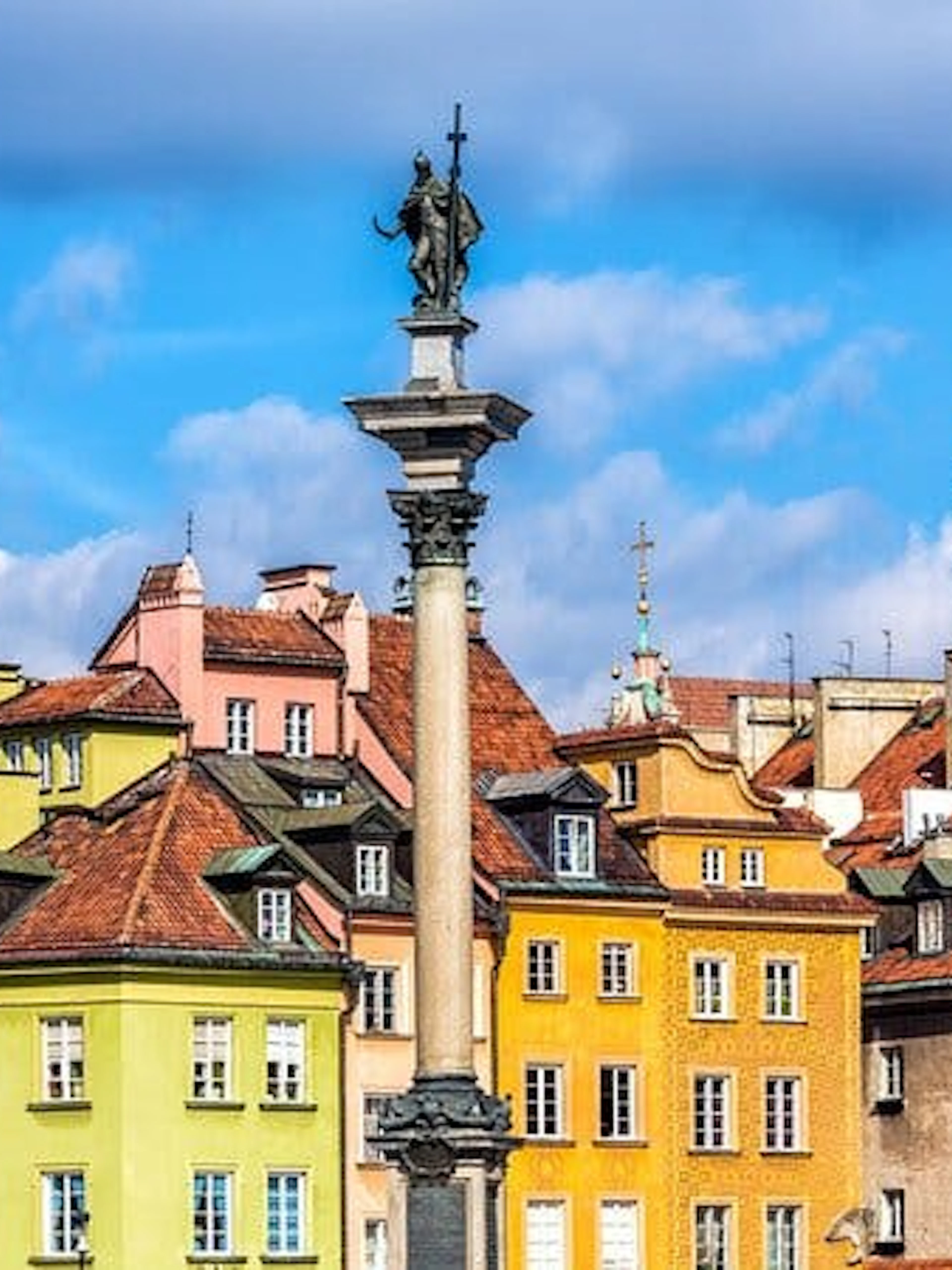 Colorful buildings and Sigismund's Column in Warsaw Old Town, Poland.