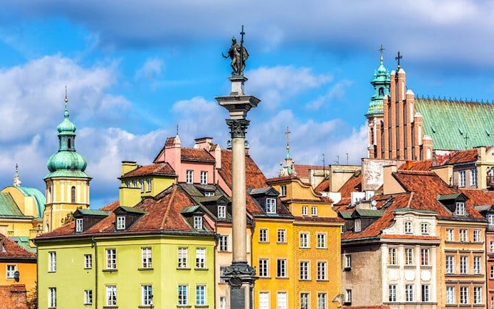 Colorful buildings and Sigismund's Column in Warsaw Old Town, Poland.