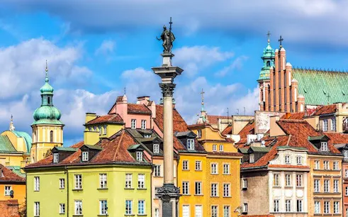 Colorful buildings and Sigismund's Column in Warsaw Old Town, Poland.