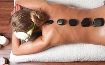 Turkish bath massage with hot stones on a woman's back in Sharm El Sheikh spa.