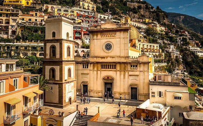 Amalfi Coast small group tour featuring historic church and colorful hillside buildings.