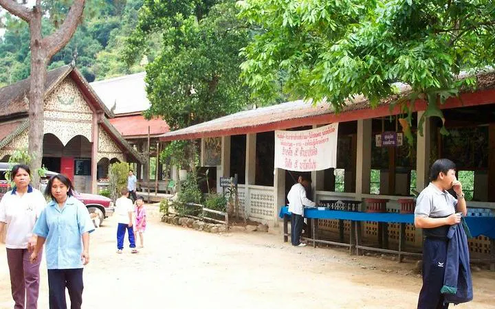 Mae Kham Pong Village scene with visitors and traditional Thai architecture, Chiang Mai.