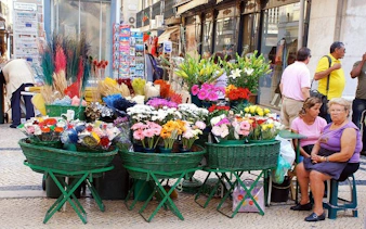 Flower market stall on a Lisbon street during a private historical city tour.