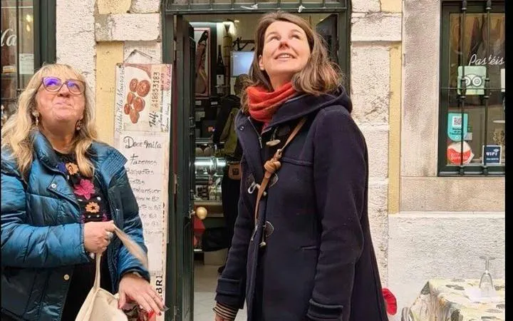 Tourists exploring Mouraria's streets on a Lisbon food and wine walking tour.