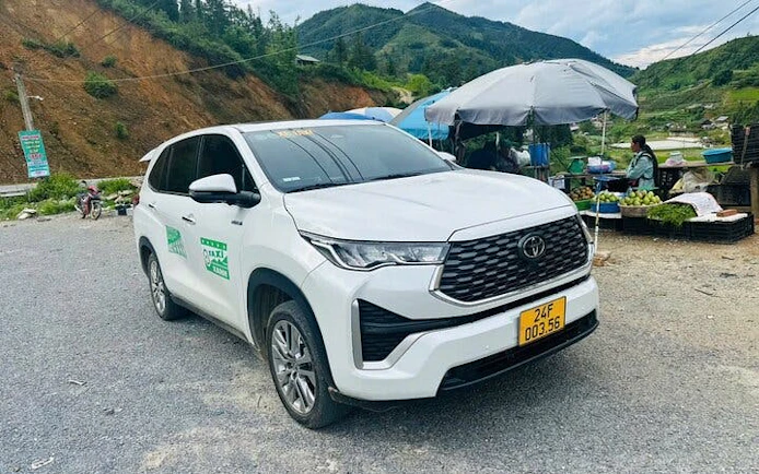 Private car parked on a rural road between Mu Cang Chai and Sa Pa, Vietnam.