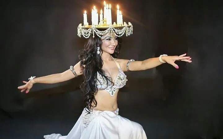 Performer with candle headdress at cabaret show, Hurghada.