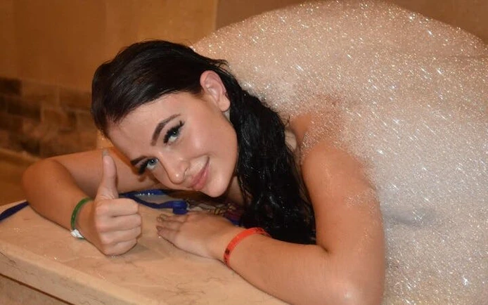 Person enjoying a bubble bath in a traditional Moroccan hammam in Marrakech.