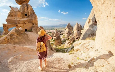 Traveler exploring Cappadocia rock formations on a private museum tour.