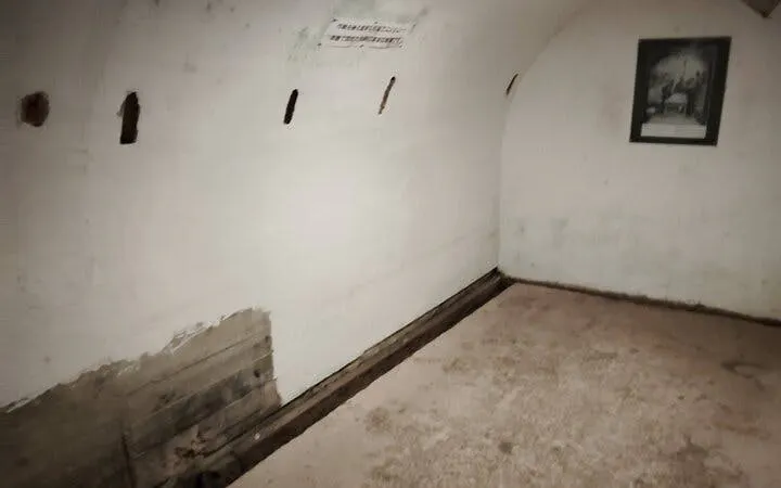Naha WWII Navy Underground HQ interior with historical photo on wall.
