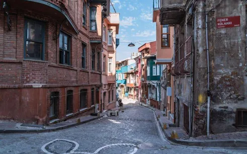 Narrow cobblestone street in Istanbul with historic buildings on a walking tour route.