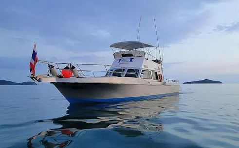 Fishing boat on calm waters near Racha Yai Island, Phuket, for big game fishing trip.
