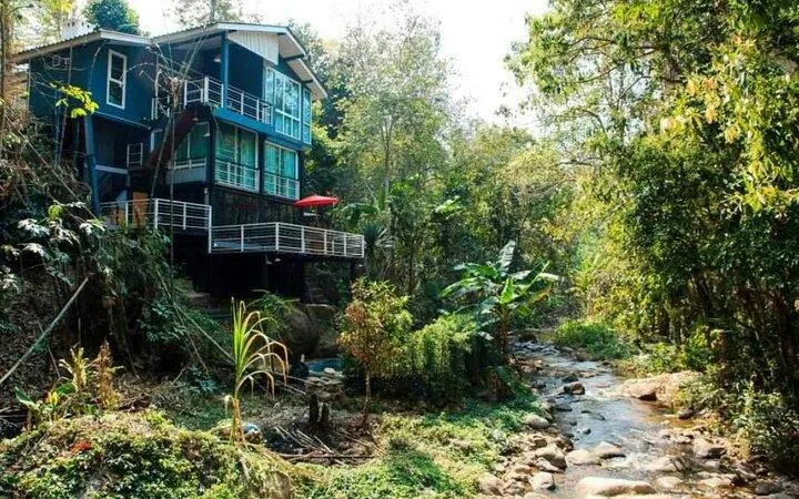 Mae Kham Pong Village house by a stream surrounded by lush greenery, Chiang Mai.