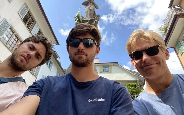 Three people in front of a statue in Zurich during a self-guided city exploration game.