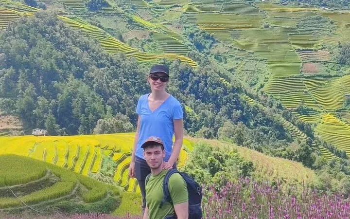 Tourists on a motorbike tour with terraced rice fields in Mu Cang Chai, Northern Vietnam.