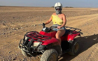 ATV rider in desert landscape at 3 Pools National Park, Dahab, Egypt.