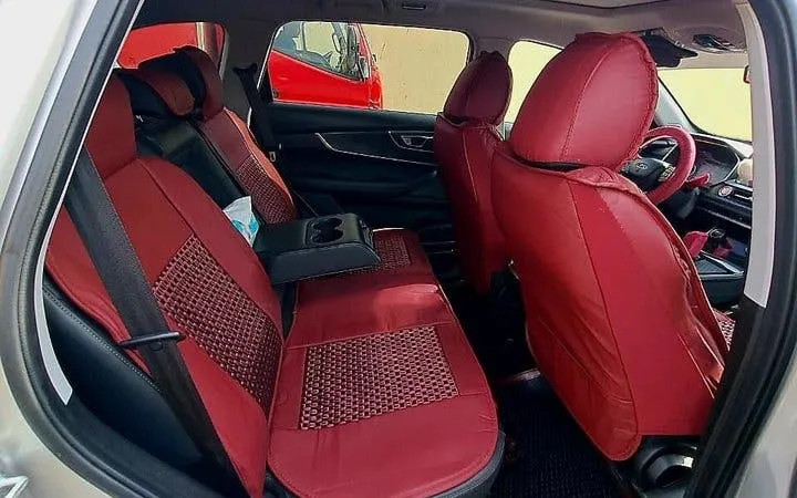 Interior of a car with red seat covers for Cairo and Giza private airport or hotel transfer.
