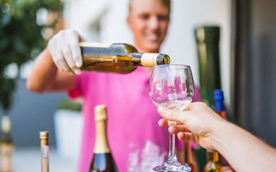 Wine being poured into a glass during Korcula wine tour tasting experience.