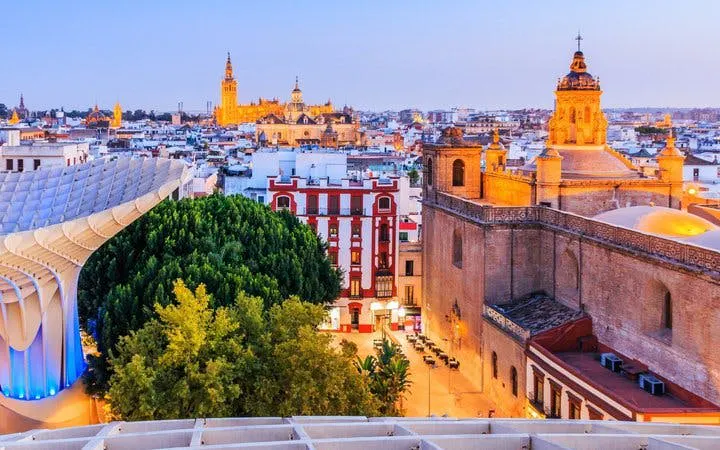 Seville skyline with Metropol Parasol and historic buildings at sunset.