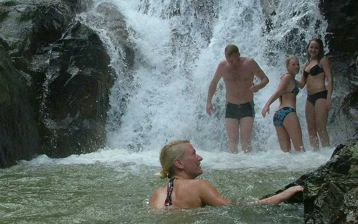 Tourists enjoying a waterfall swim during Koh Samui 4WD Jeep Safari Tour.