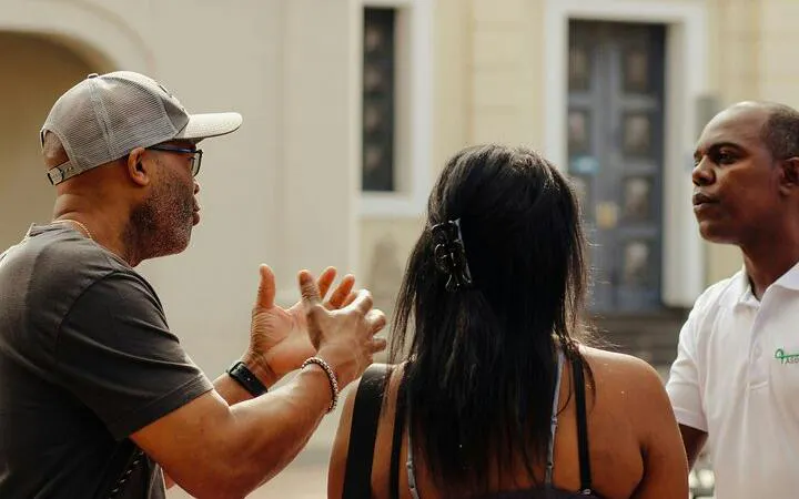 Tour guide explaining Santo Domingo landmarks to visitors during guided tour.