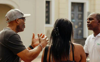 Tour guide explaining Santo Domingo landmarks to visitors during guided tour.