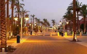 Palm-lined promenade in Hurghada at dusk, part of a private city tour with seafood lunch.