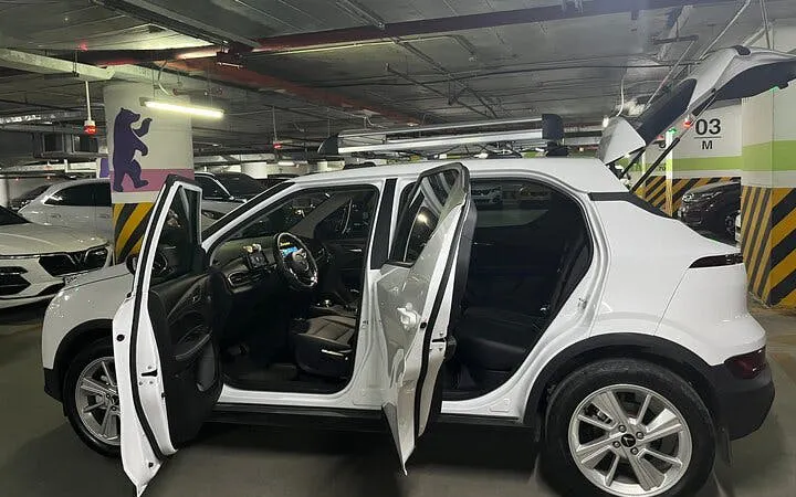 Private car for Sapa to Ha Giang City transfer with open doors in a parking garage.